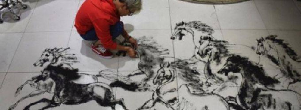 حلاق صيني يستعمل شعر زبائنه في رسم لوحات فنية
