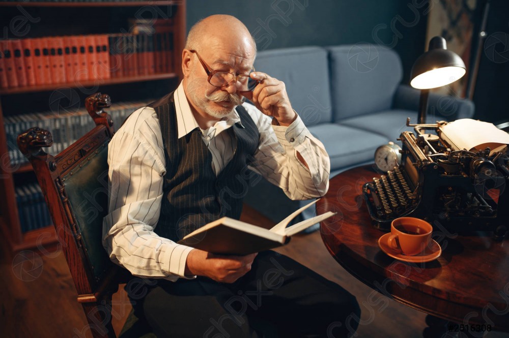 elderly-writer-reads-work-vintage-2516308