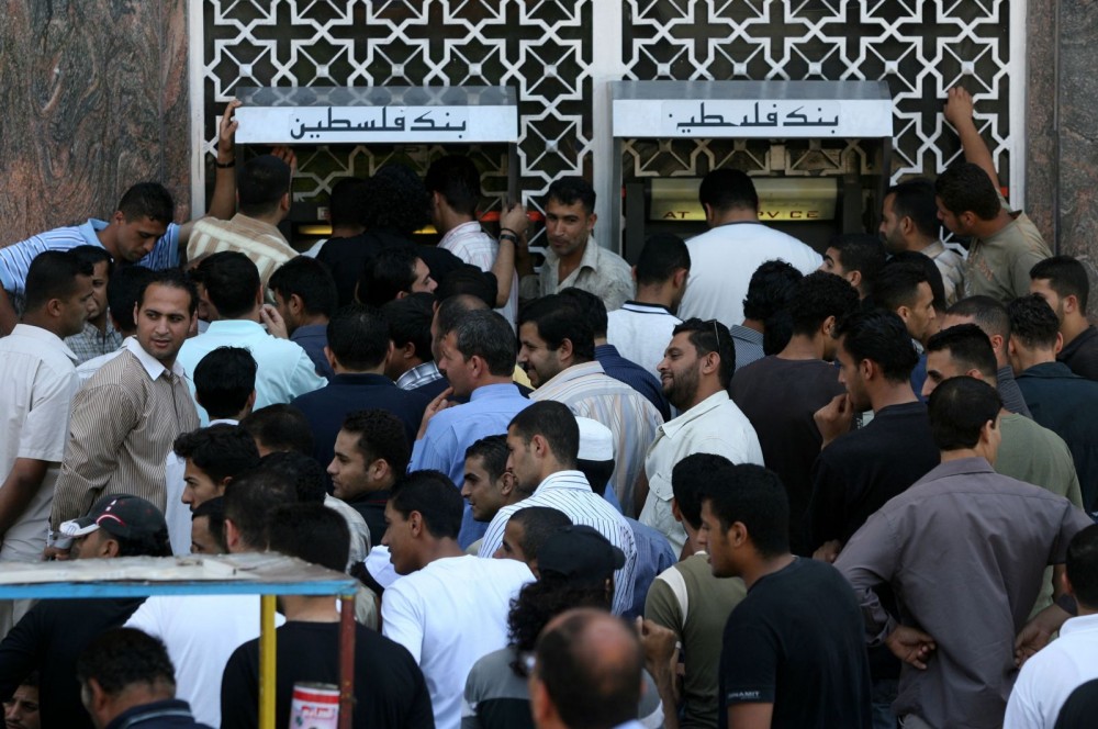 Palestinian-Authority-employees-line-up-in-front-of-a-bank-to-receive-their-salaries-after-four-days-of-delaying