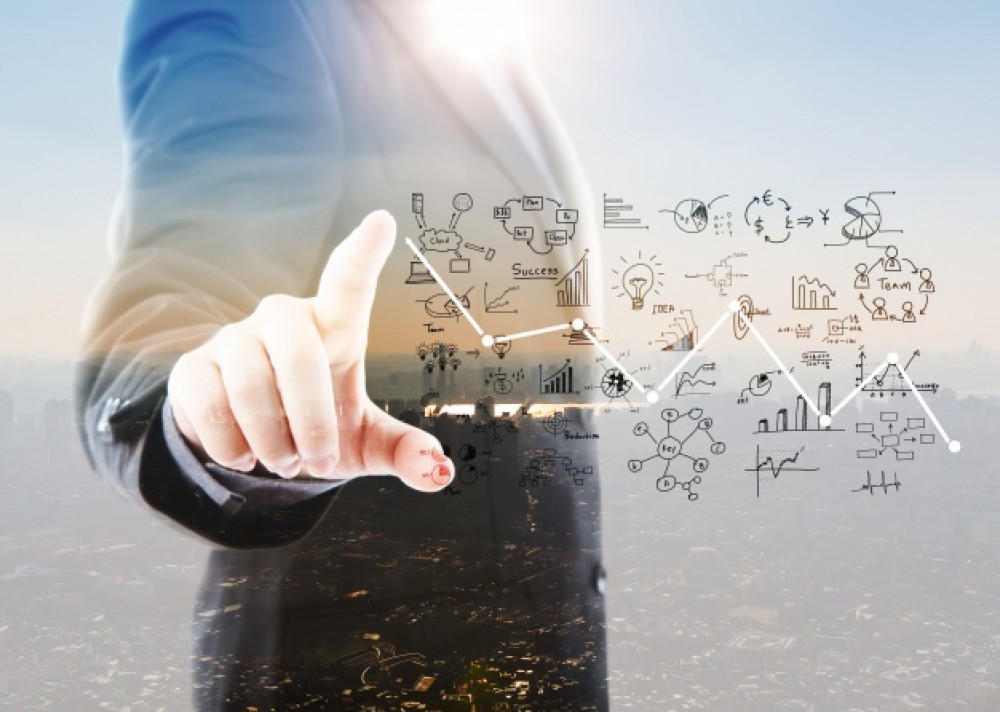 businessman-pointing-graphs-and-symbols_1232-917
