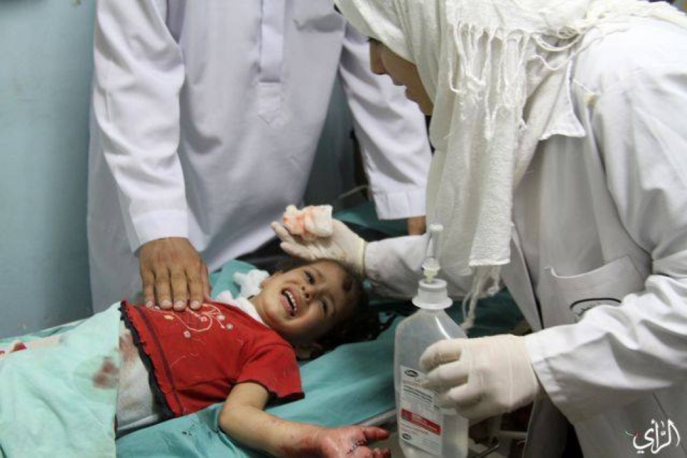 إحدى موظفات غزة أثناء إسعافها لأحد أطفال العدوان